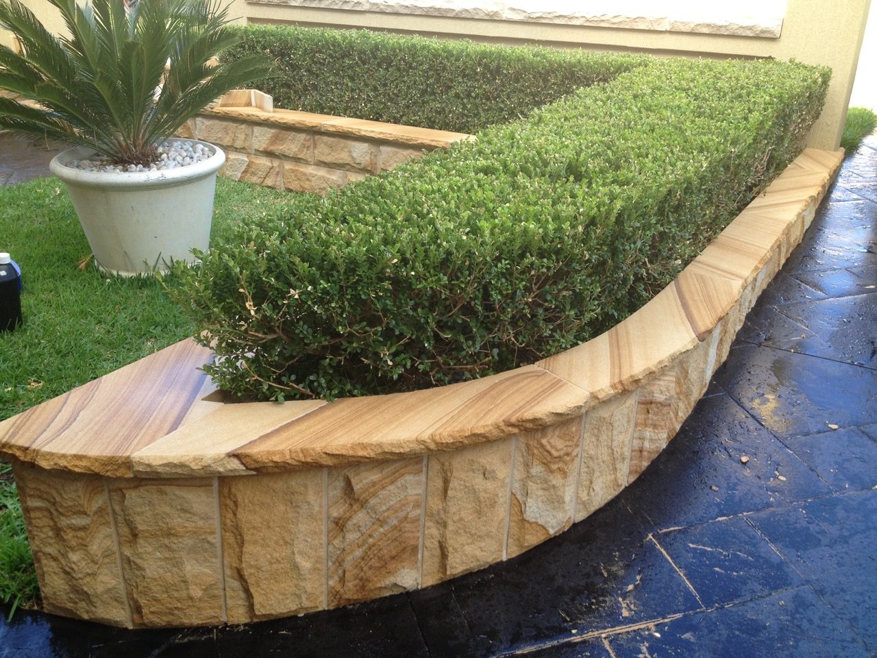 Curved garden retaining wall — Mega Stoneworks, Sydney